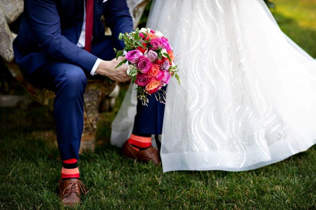 Bride and Groom Sitting on Bench