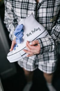 Bride Holding Canvas Sneakers with Blue Ribbon